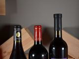 three bottles of wine sitting on a table next to each other