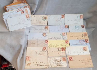 many old letters and envelopes laid out on a table