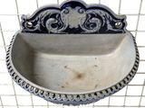 a metal sink with a decorative design on it