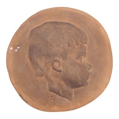 an old coin with a picture of a young boy on it