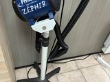 a blue and black blow dryer sitting on a tripod
