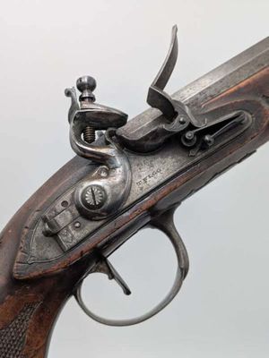 a close up of a gun that is on display on a table