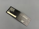 a close up of a black and white business card sitting on a table