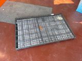 a metal tray on the floor next to a mat