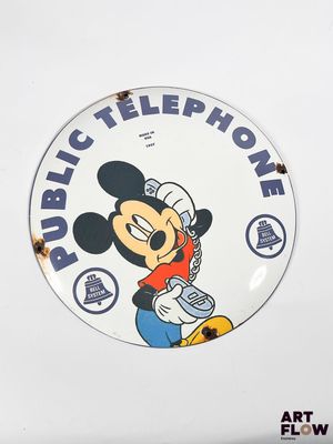 disney mickey mouse public telephone sign on a white wall