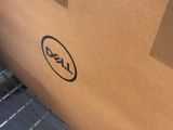 a box with a dell logo on it sitting on a shelf