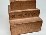 a statue of a man sitting on top of a set of stairs