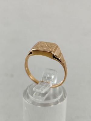 an image of a gold signet ring with a diamond in the center
