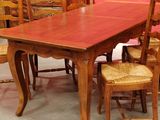 a table and chairs in a room with a pink wall