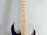 an electric guitar sitting on top of a white surface