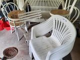 several chairs and a table in a room with a lot of stuff on the floor