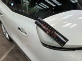 a sticker on the side of a white car