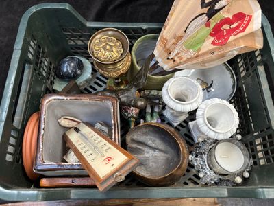 a green basket filled with assorted items on a table