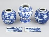 three blue and white vases sitting next to each other