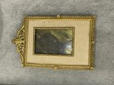 an image of a picture of a bear in a frame hanging on a wall