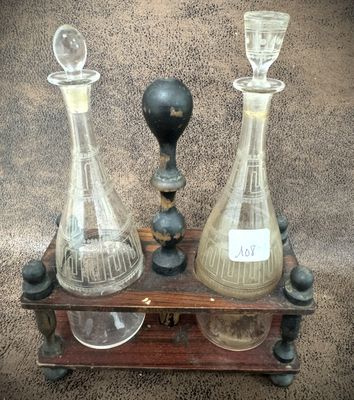 three glass vases sitting on a wooden stand