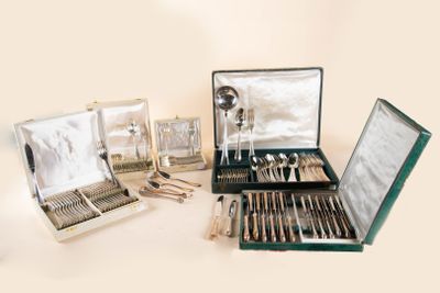 a lot of silverware in a case on a table