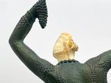 a statue of a woman holding a bunch of grapes in her hand