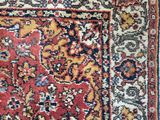 an antique persian rug with a red and blue border