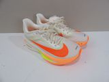 a pair of white and orange sneakers on a white surface