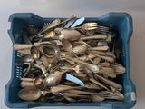 a lot of spoons and forks in a blue container