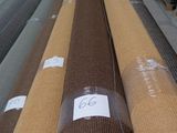 many rolls of fabric on a conveyor belt in a warehouse