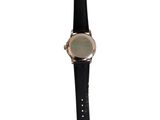 a close up of a watch on a white background with a black strap