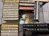 many books stacked on top of each other on a shelf