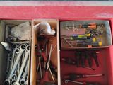 many tools in a tool box on the floor
