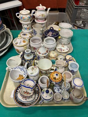 un plateau sur lequel sont posées de nombreuses tasses et soucoupes