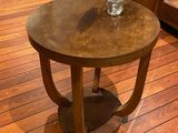 a small table with a bowl on it on a wooden floor