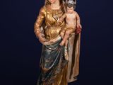 a statue of a woman holding a child wearing a crown