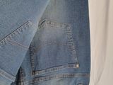 the back of a pair of jeans hanging on a hanger