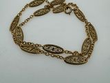 a gold chain bracelet with a leaf design