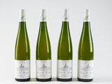 three bottles of wine are lined up on a white surface