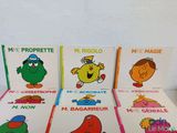 several children ' s books are lined up in a row on a table