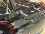 a close up of a car door handle with a sticker on it