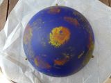 a blue ball with orange spots on it sitting on a table