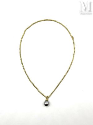 a necklace with a black pearl on a gold chain