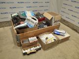boxes of assorted electronics are sitting on the floor in front of a wall