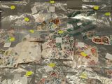 many different stamps on a plastic bag with stickers on it