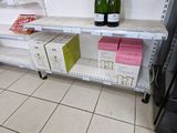 two bottles of wine on a shelf in a store