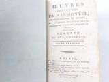 an old book that is open on a table