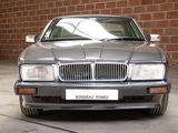 a silver car parked in a garage with a brick wall behind it