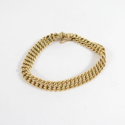 a gold chain bracelet with a clasp on a white background