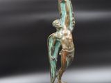 an image of a bronze statue of a man holding a bird