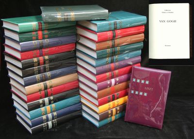 several books stacked on top of each other on a black surface