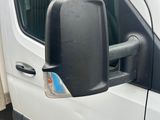 an image of a side view mirror of a white van