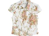 the shirt is white and has a floral print on it