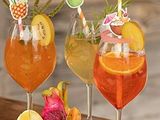 three glasses filled with different types of drinks on a table